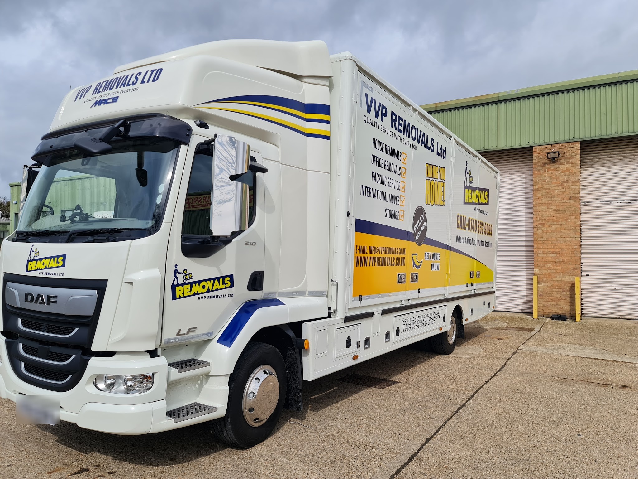 The newest VVP Removals lorry, in full navy and amber livery, outside a warehouse unit